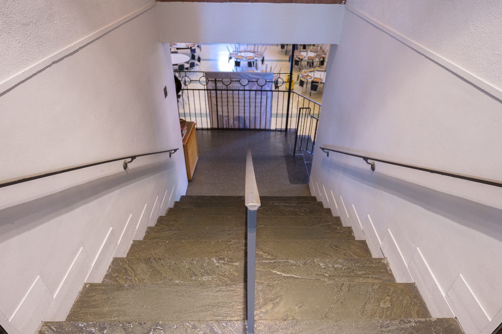 A stairwell between two floors of the parish complex, with no elevator alternative.