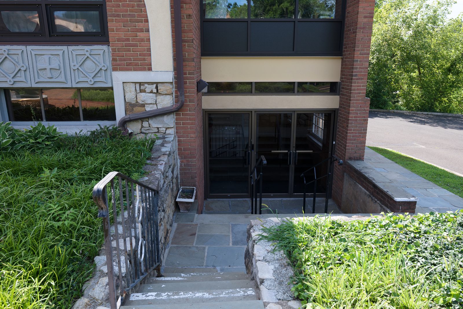 The exterior entrance to the social hall, reached only by a flight of stairs down from ground level.